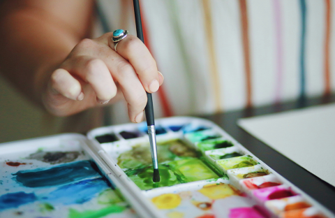 Woman painting with various colors