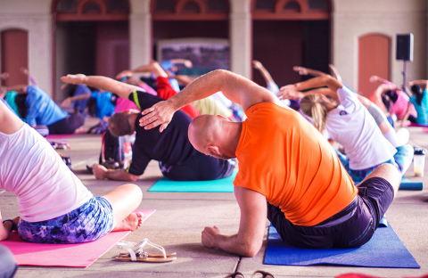 Group of people stretching during a yoga program