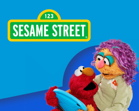 Elmo the Sesame Street monster playing on an electronic tablet with his mother on a bright blue background under the Sesame Street street sign logo.